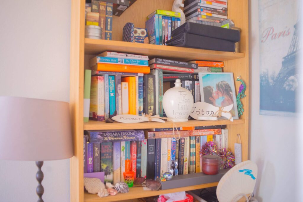 Cosy bookshelf of books and ornaments we packed when we moved abroad