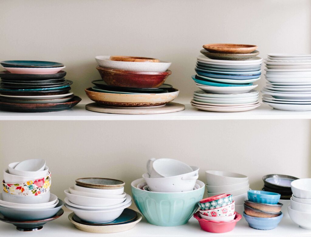 Plates and Bowls stacked up on a shelf