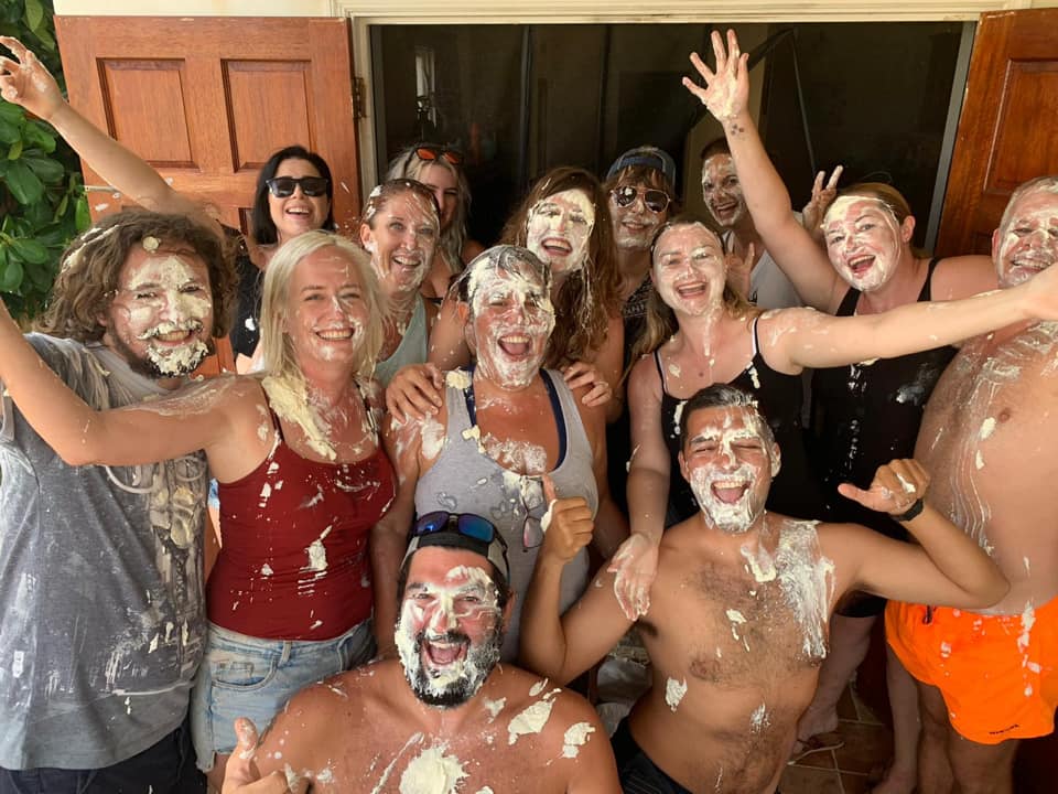 A group of people covering in whipped cream at a party